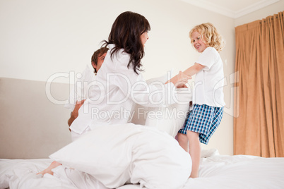 Playful family having pillow fight