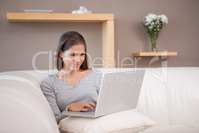 Woman with notebook on her sofa