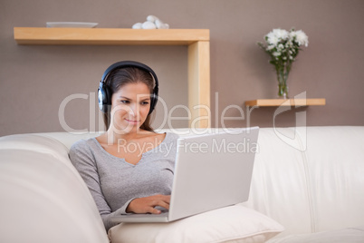 Woman with headphones on her laptop