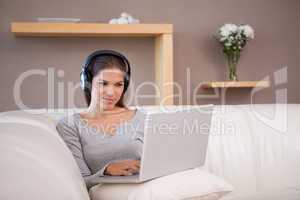 Woman with headphones on her laptop