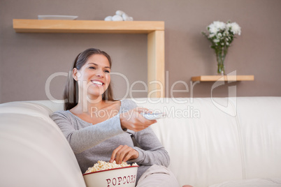 Woman watching a movie with a bowl of popcorn