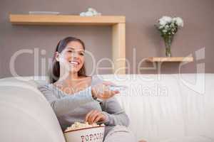 Woman watching a movie with a bowl of popcorn