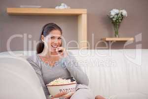 Woman eating popcorn while watching movie