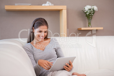 Woman with tablet pc on the sofa