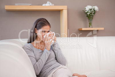 Woman drinking some coffee on the sofa