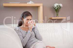 Woman drinking some coffee on the sofa