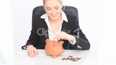 Smiling Businesswoman And Her Piggy Bank