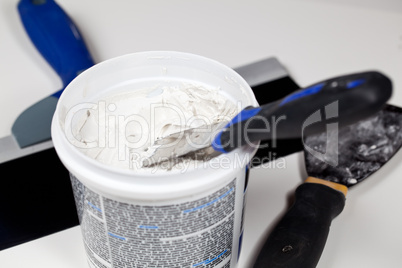 Spackling knive in plaster