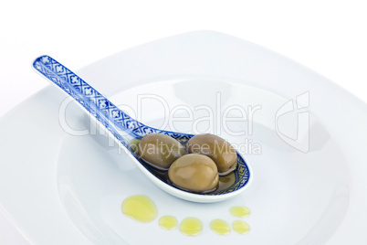 Olives on  spoon.