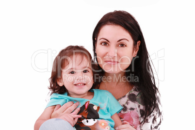 Smiling embracing mom and daughter looking at camera