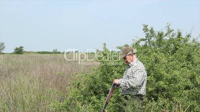 hunter loading shotgun and shooting