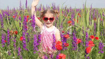 little girl standing in colorful meadow