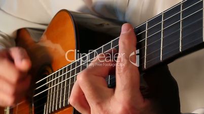 Playing classical guitar music.