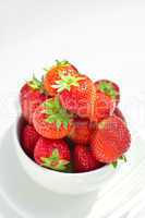 strawberries in a bowl in the daylight