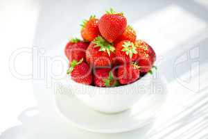 strawberries in a bowl in the daylight