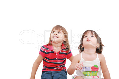 Two little girl looking up, two and four years old, isolated on