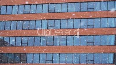 Snowfall against an office building