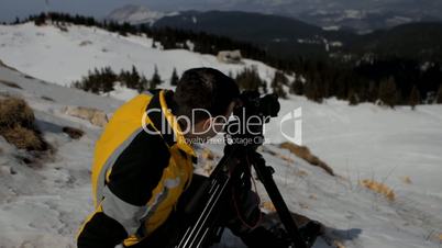 Man taking picture on mountain