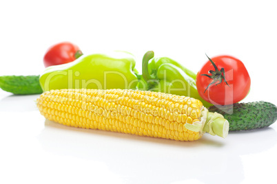 tomatoes, peppers, cucumbers and corn isolated on white