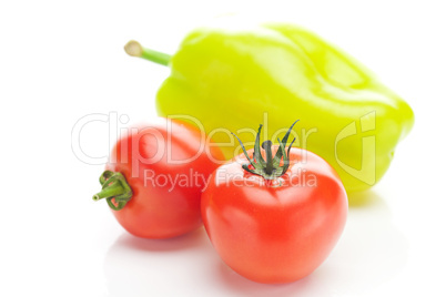 red ripe tomatoes and peppers isolated on white