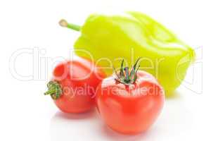 red ripe tomatoes and peppers isolated on white