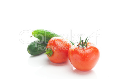 red ripe tomato and cucumber isolated on white