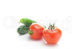 red ripe tomato and cucumber isolated on white