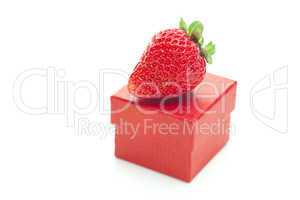 red gift box and strawberries isolated on white