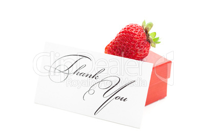 red gift box, thank you card and strawberries isolated on white