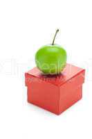 red gift box and green plum isolated on white