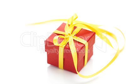 red gift box with a yellow ribbon isolated on white