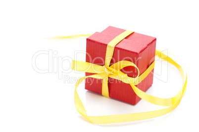 red gift box with a yellow ribbon isolated on white