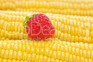 background of ripe yellow corn and strawberry