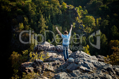 young man standing on a rock slope