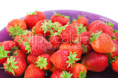 strawberries in a glass plate isolated on white