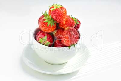 strawberries in a bowl in the daylight