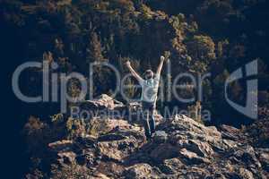 young man standing on a rock slope