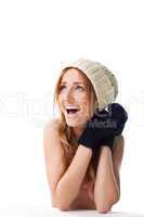 Happy blond woman in mitten and cap