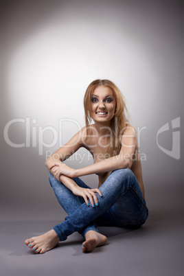 half nude woman sit in jeans