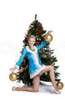Sexy christmas girl posing with gold balls