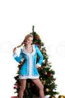 Young christmas girl stand with new year fir tree