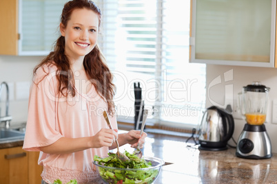 Woman stirring salad