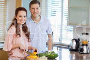Couple in the kitchen preparing salad