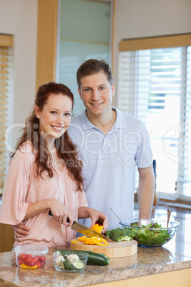 Male watching his girlfriend preparing salad