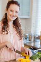 Woman cutting ingredients for salad