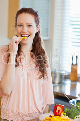 Woman eating bell pepper