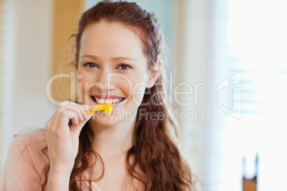 Woman about to bite into bell pepper