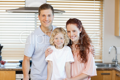 Family standing together in the kitchen
