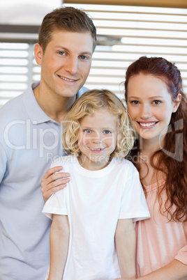 Smiling family standing in the kitchen