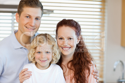 Cheerful family standing in the kitchen